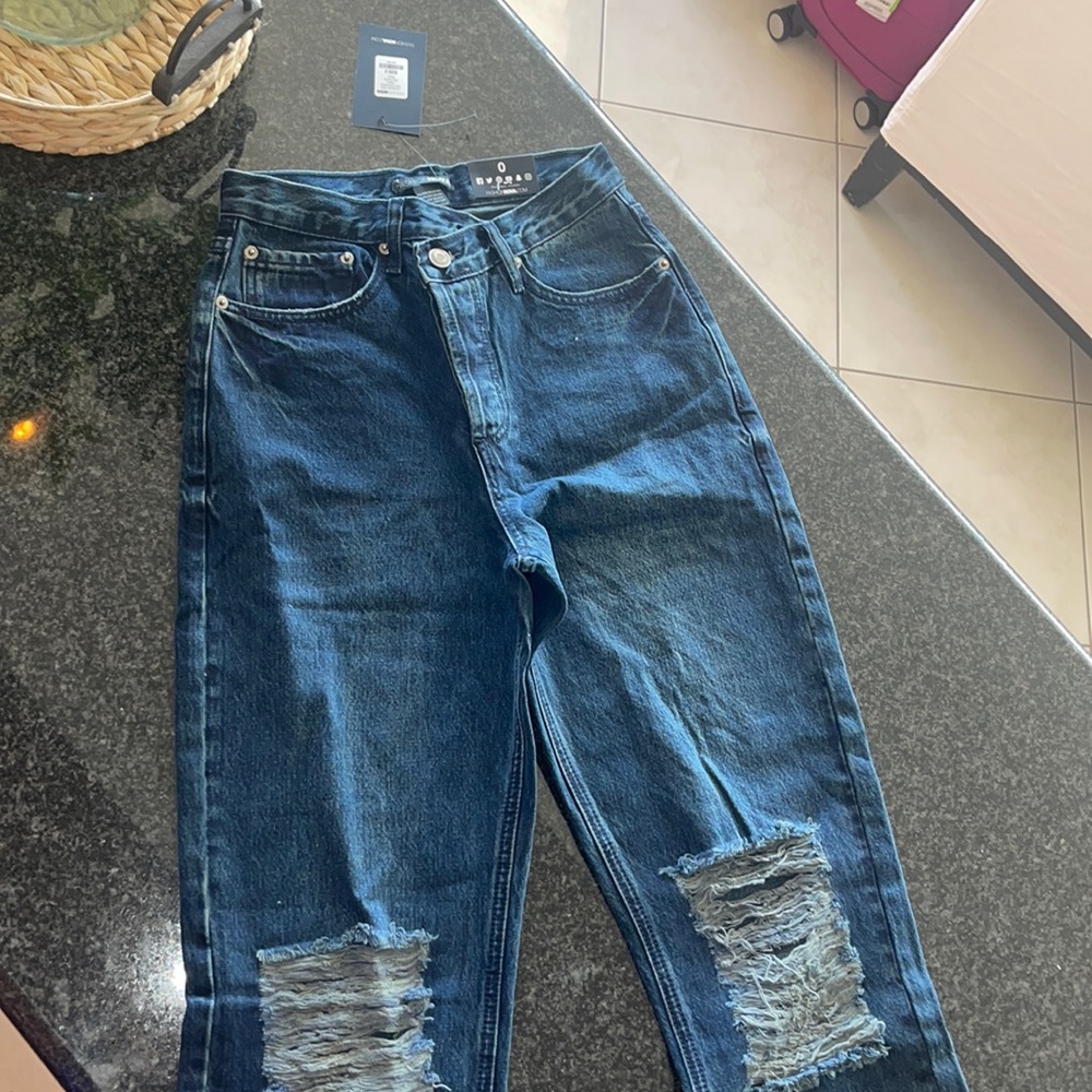 Fashionnova expensive jeans , High waisted , flare. Ripped , open pant jeans .